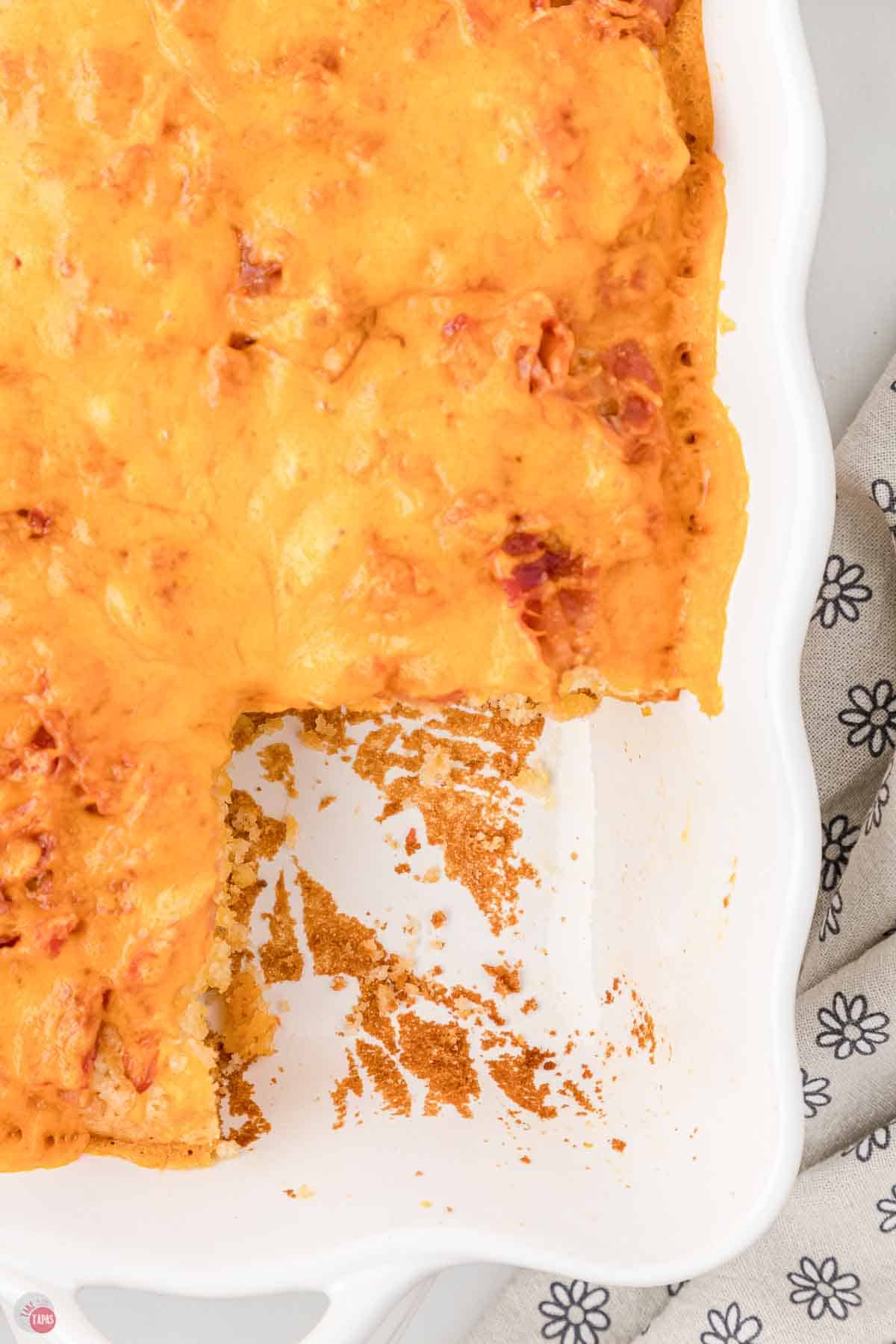 bacon pancake casserole in a white baking dish with a square removed