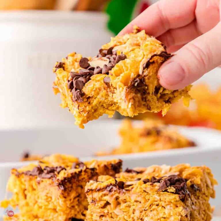 hand holding a cornflake bar with a bite missing