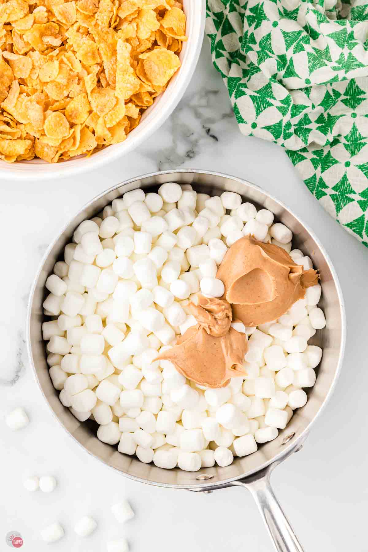 mini marshmallows in a pot with a cup of peanut butter