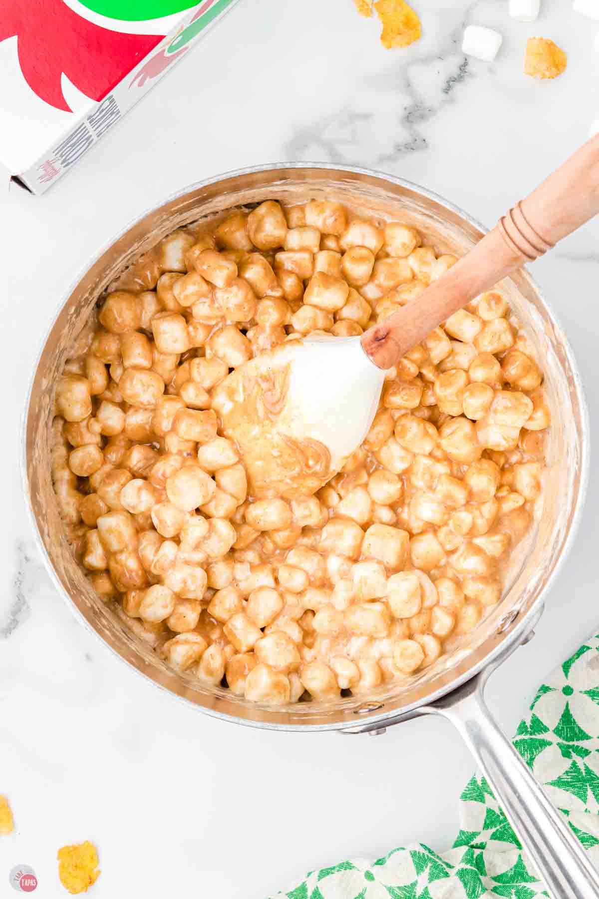 pot of peanut butter and marshmallows stirred together