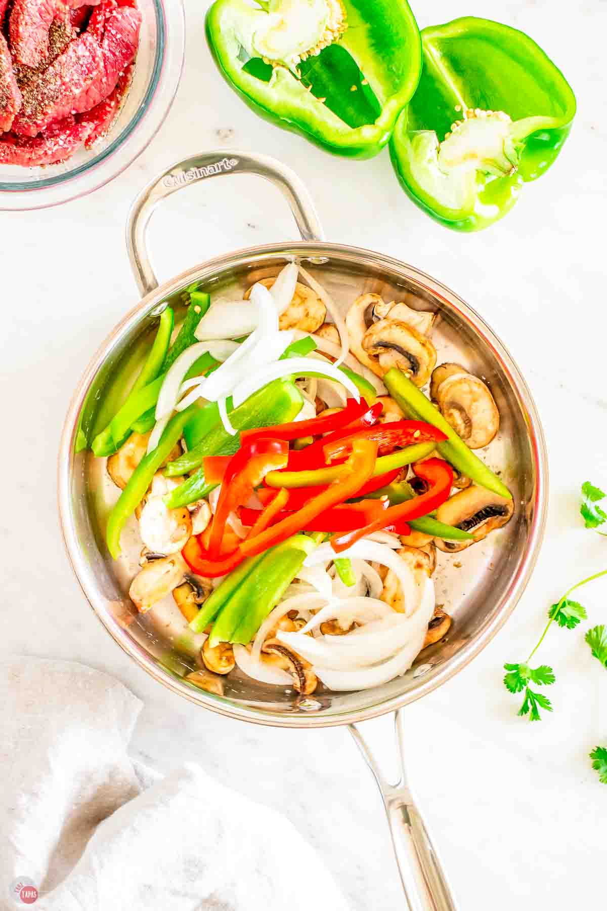 peppers and onions cooking in a skillet