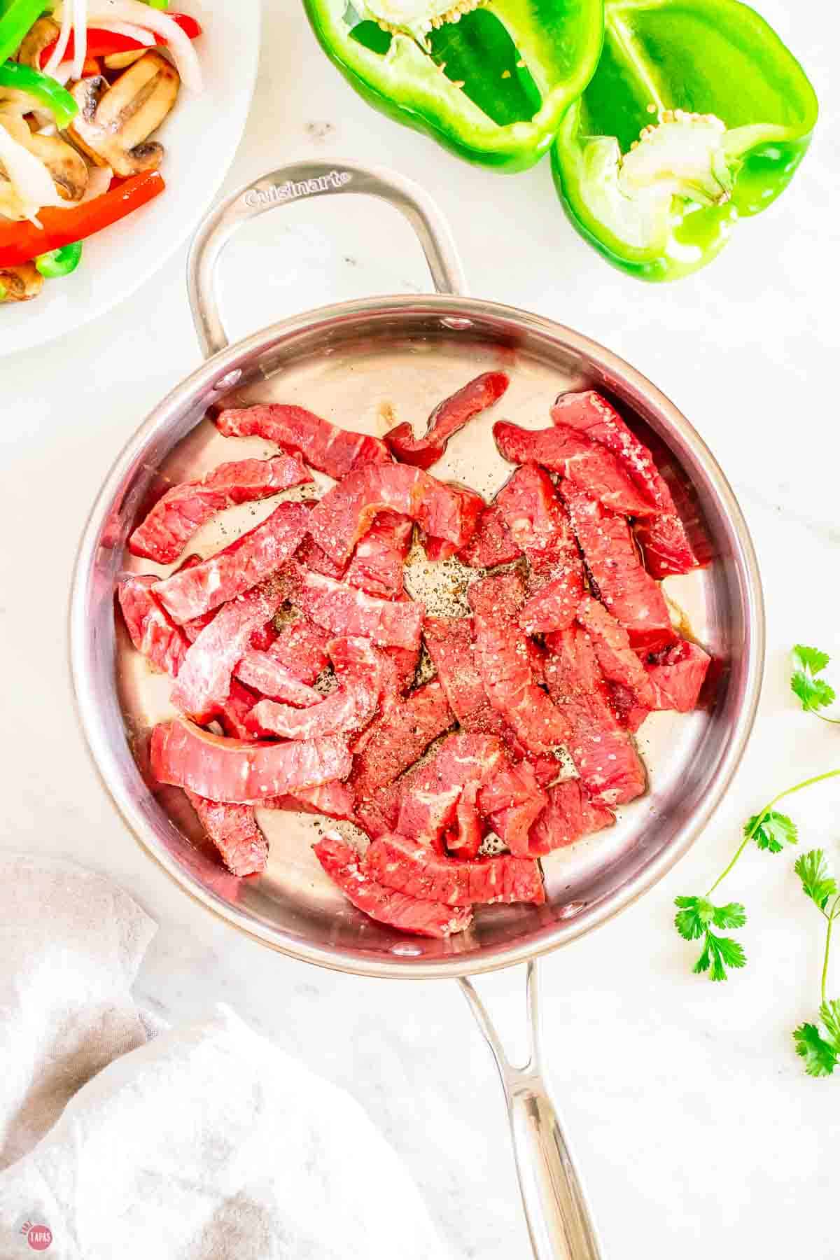 sliced steak cooking in a skillet