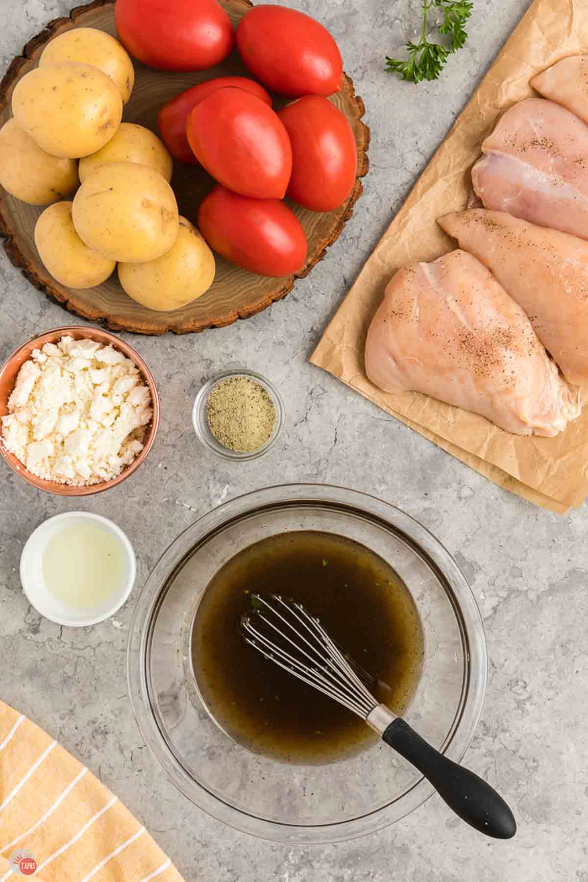 small clear bowl with a marinade in it being whisked together