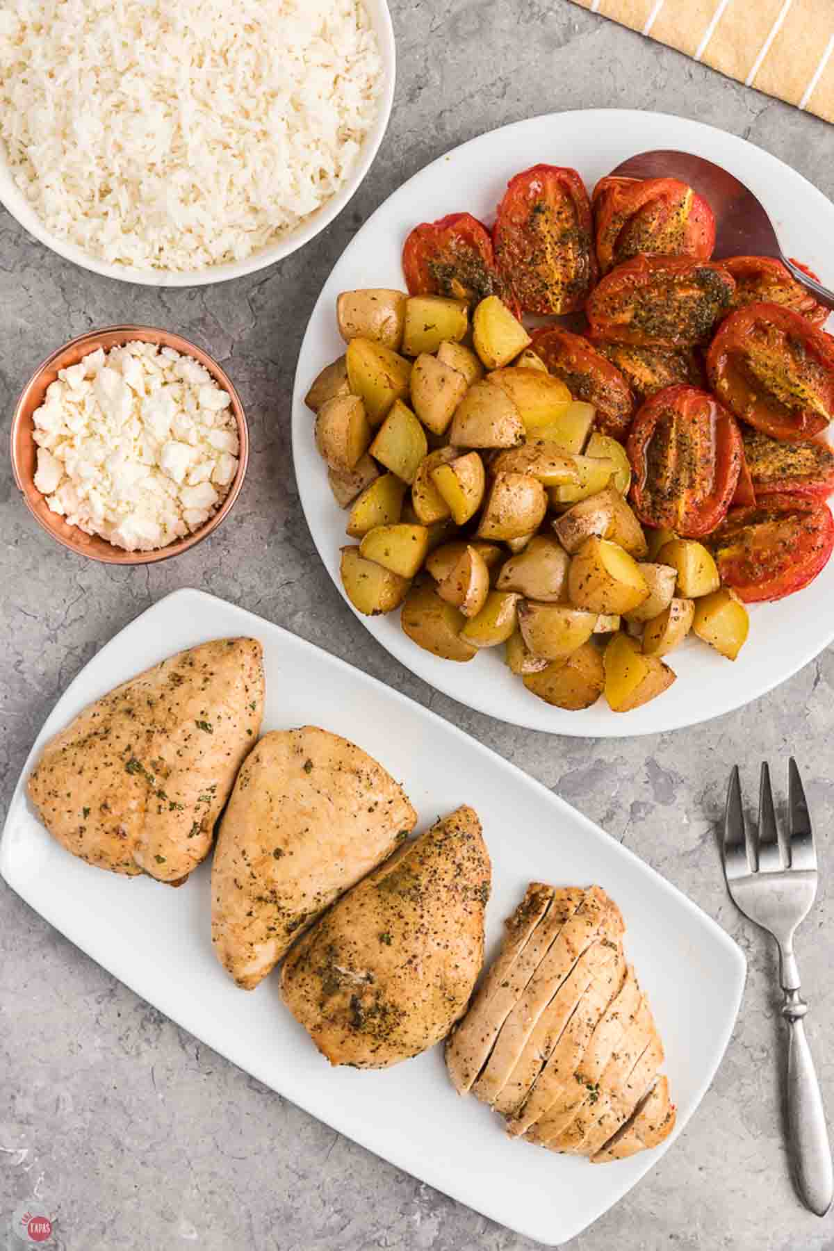 4 pieces of chicken on a plate with vegetables on a separate one