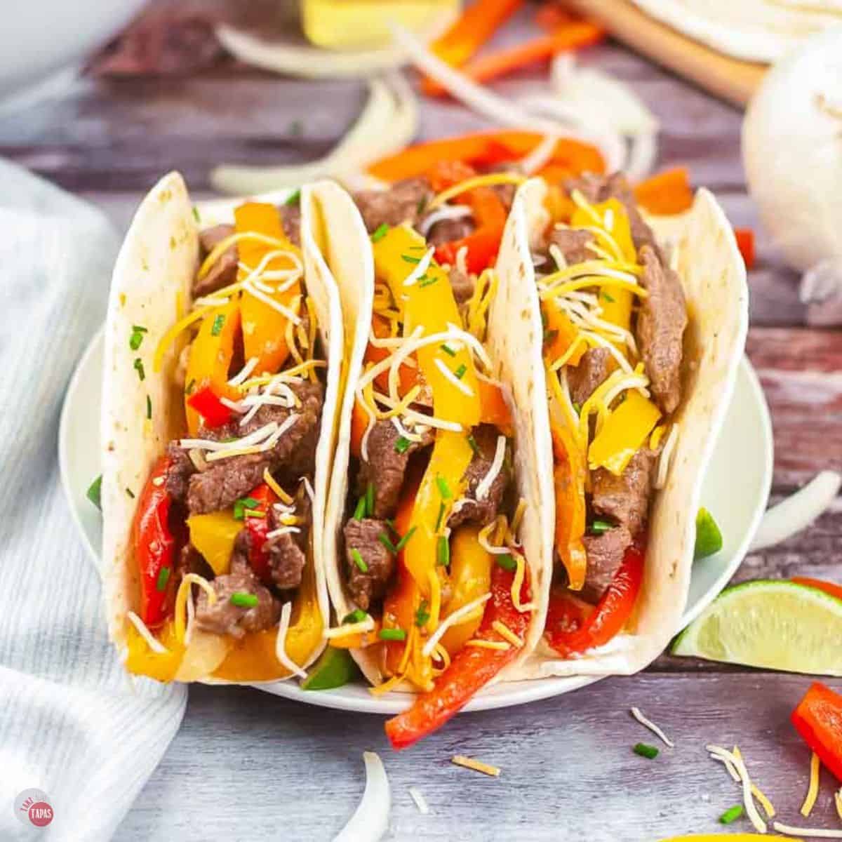 plate of three steak fajitas with cheese