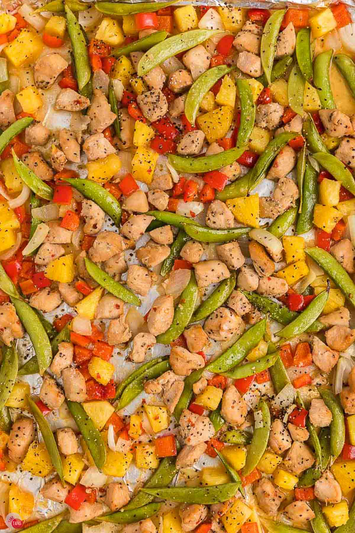 close up of sweet and sour chicken on a sheet pan