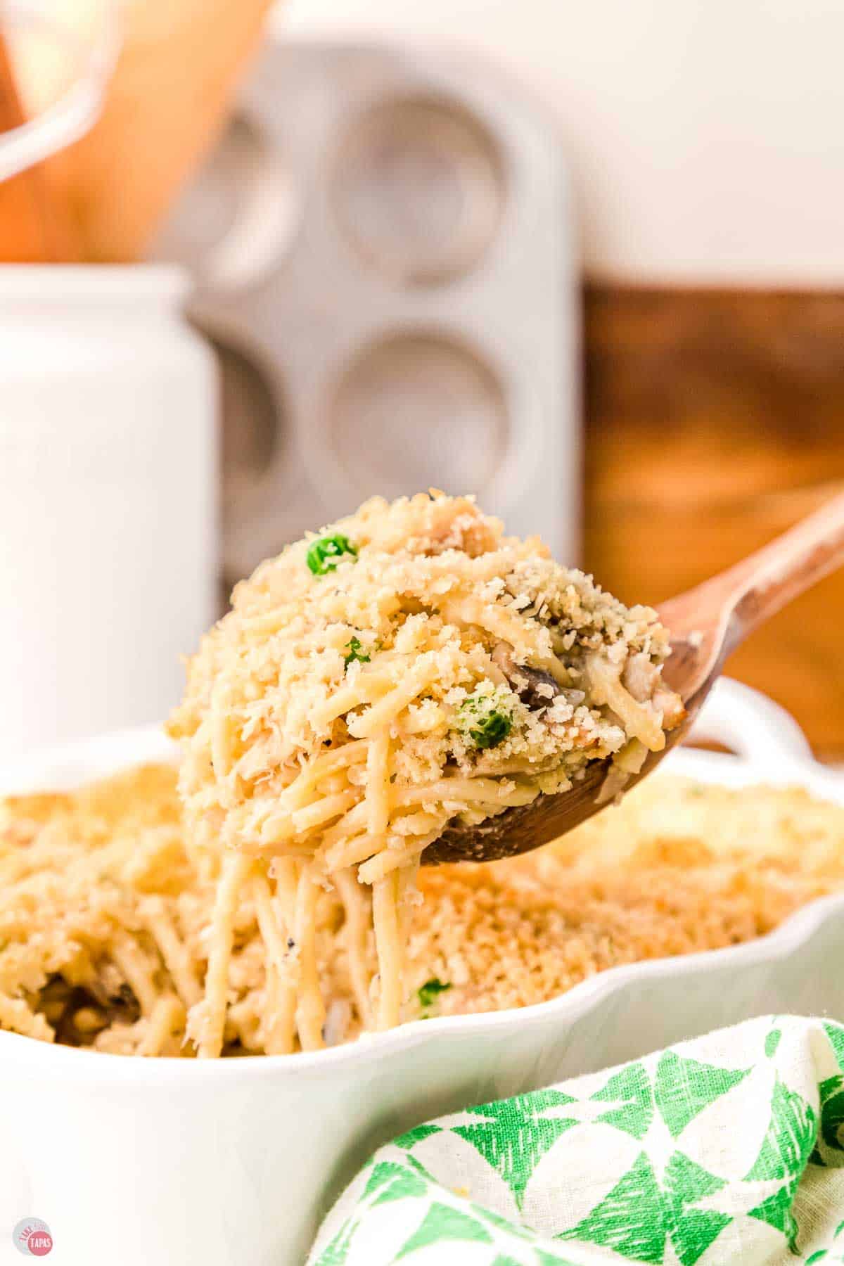 wood spoon scooping tuna tetrazzini out of a dish