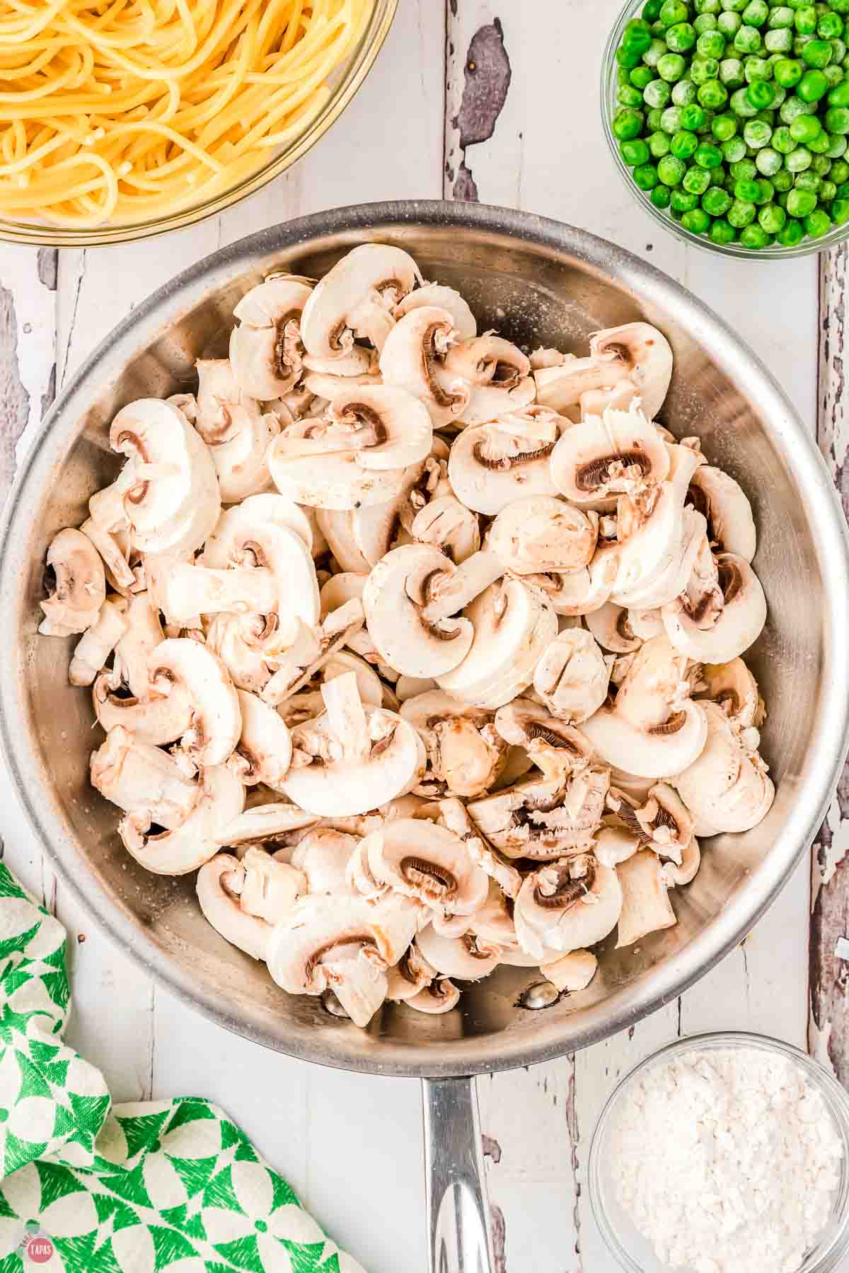 sliced mushrooms in a silver skillet
