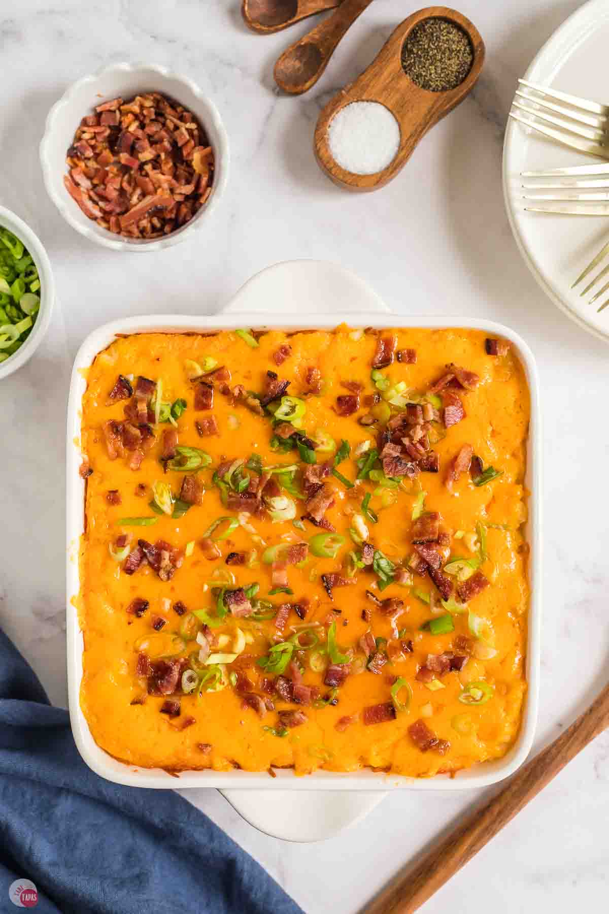 twice baked potato casserole in a square white baking dish