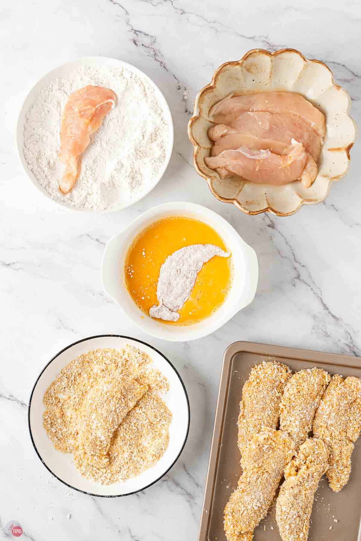chicken tenders being dredged into three different coatings