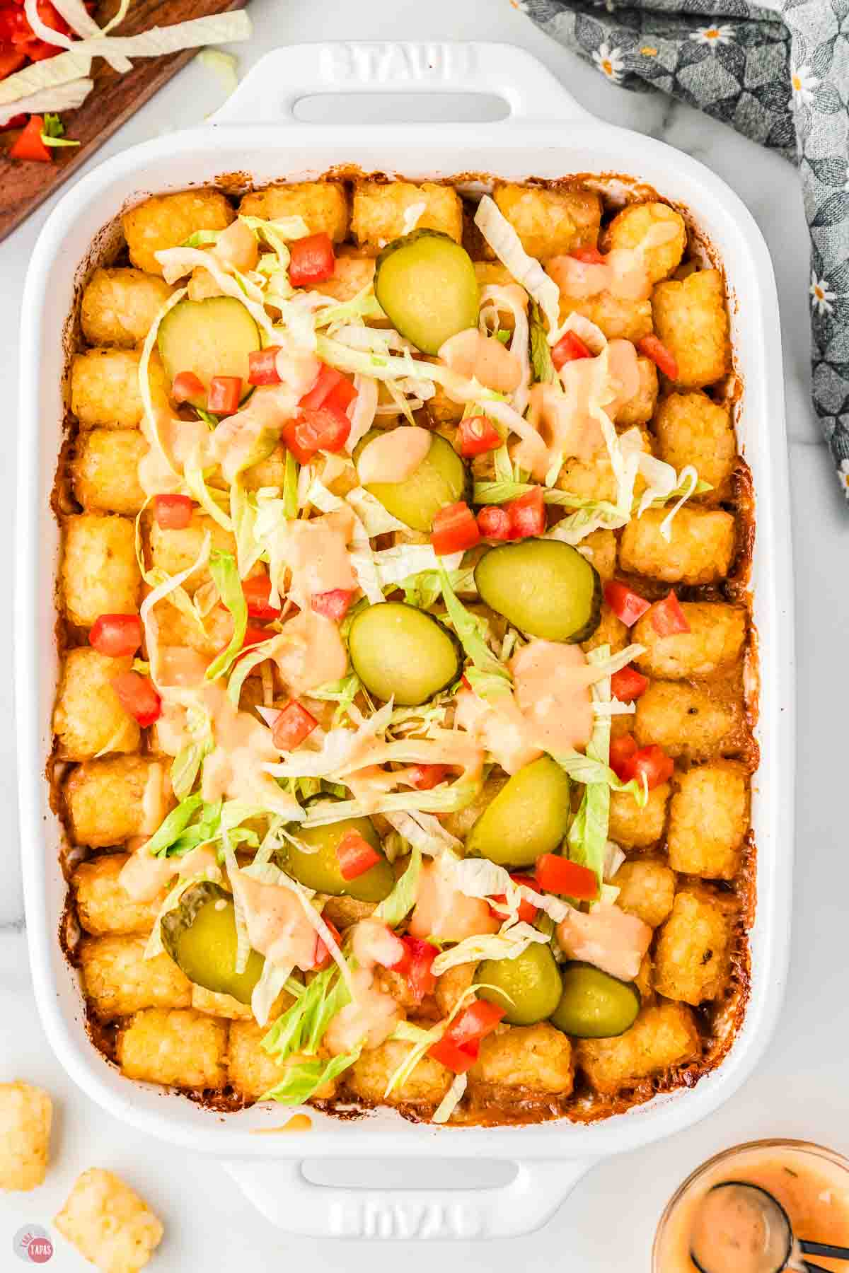 overhead picture of big mac casserole with tater tots in a white dish