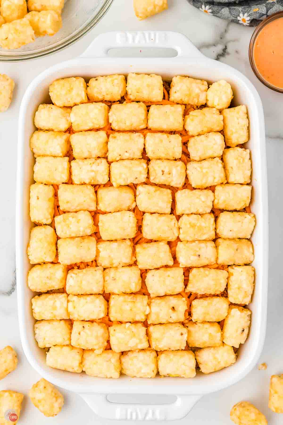 baking dish with a layer of frozen tater tots