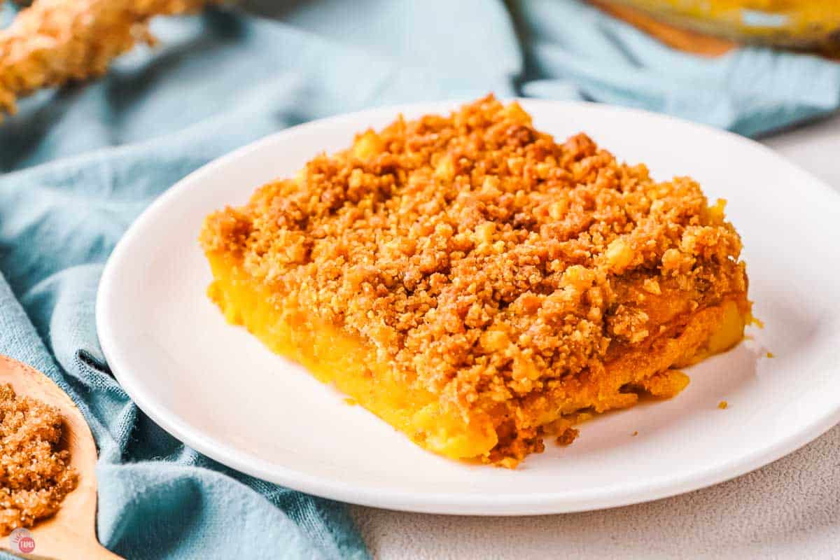 close up of slice of sweet potato casserole on a white plate