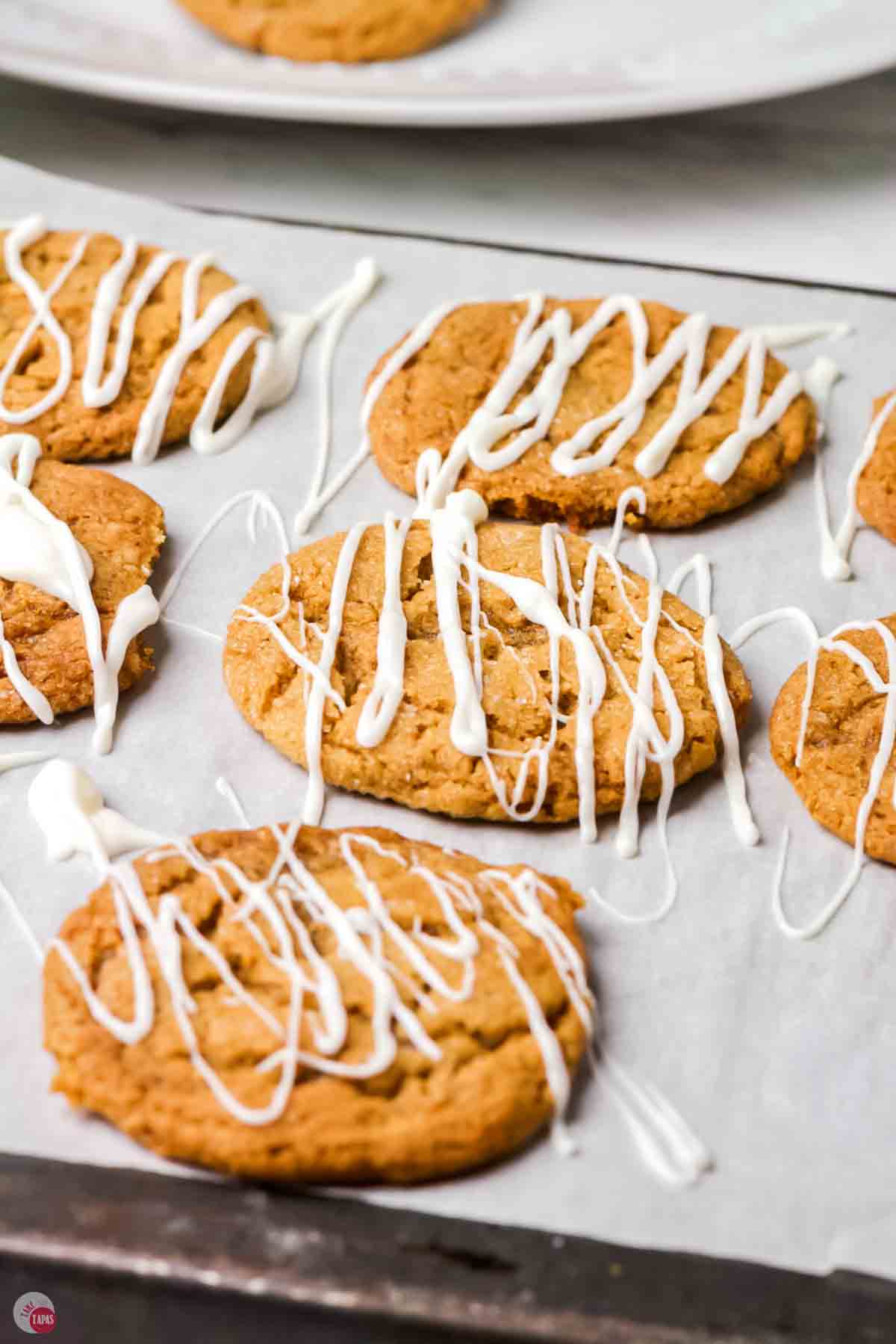white chocolate being drizzled on a cookie