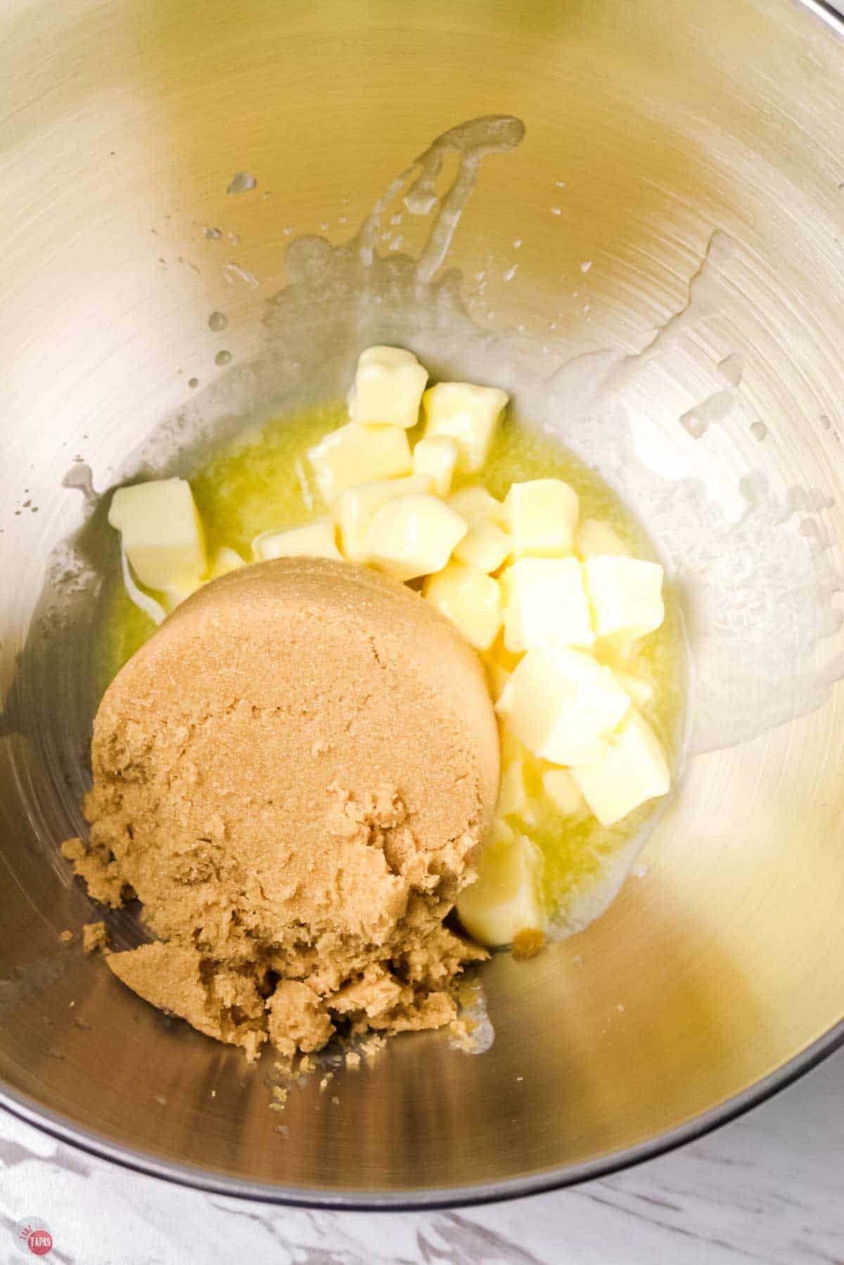 mixing bowl with cubed butter and light brown sugar in it