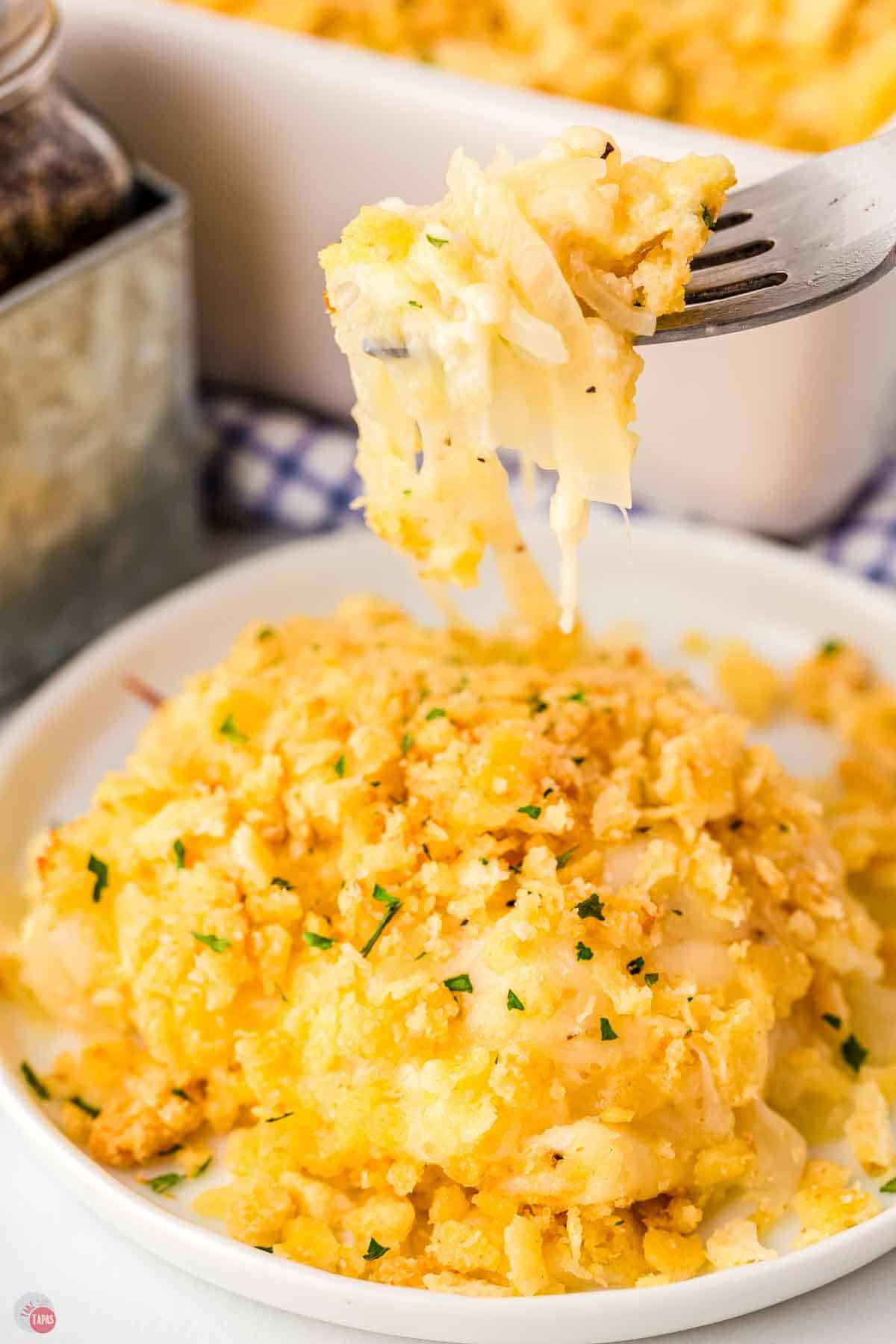 fork with a bite of onion casserole over a white plate