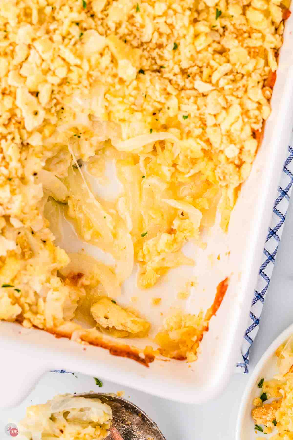 onion casserole in a white baking dish with a scoop missing