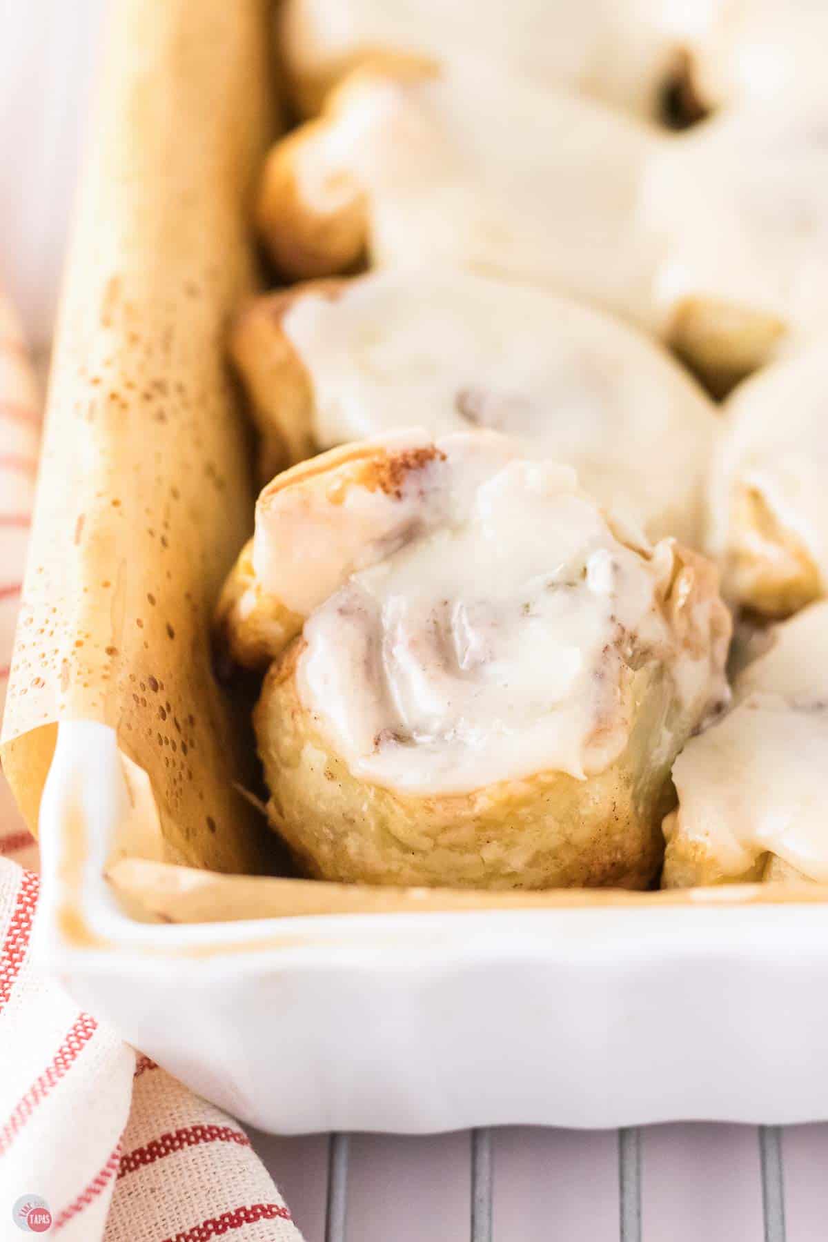 white baking dish with puff pastry cinnamon rolls in it