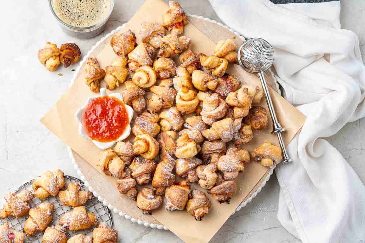 overhead picture of rugelach cookies with a small bowl of pepper jelly