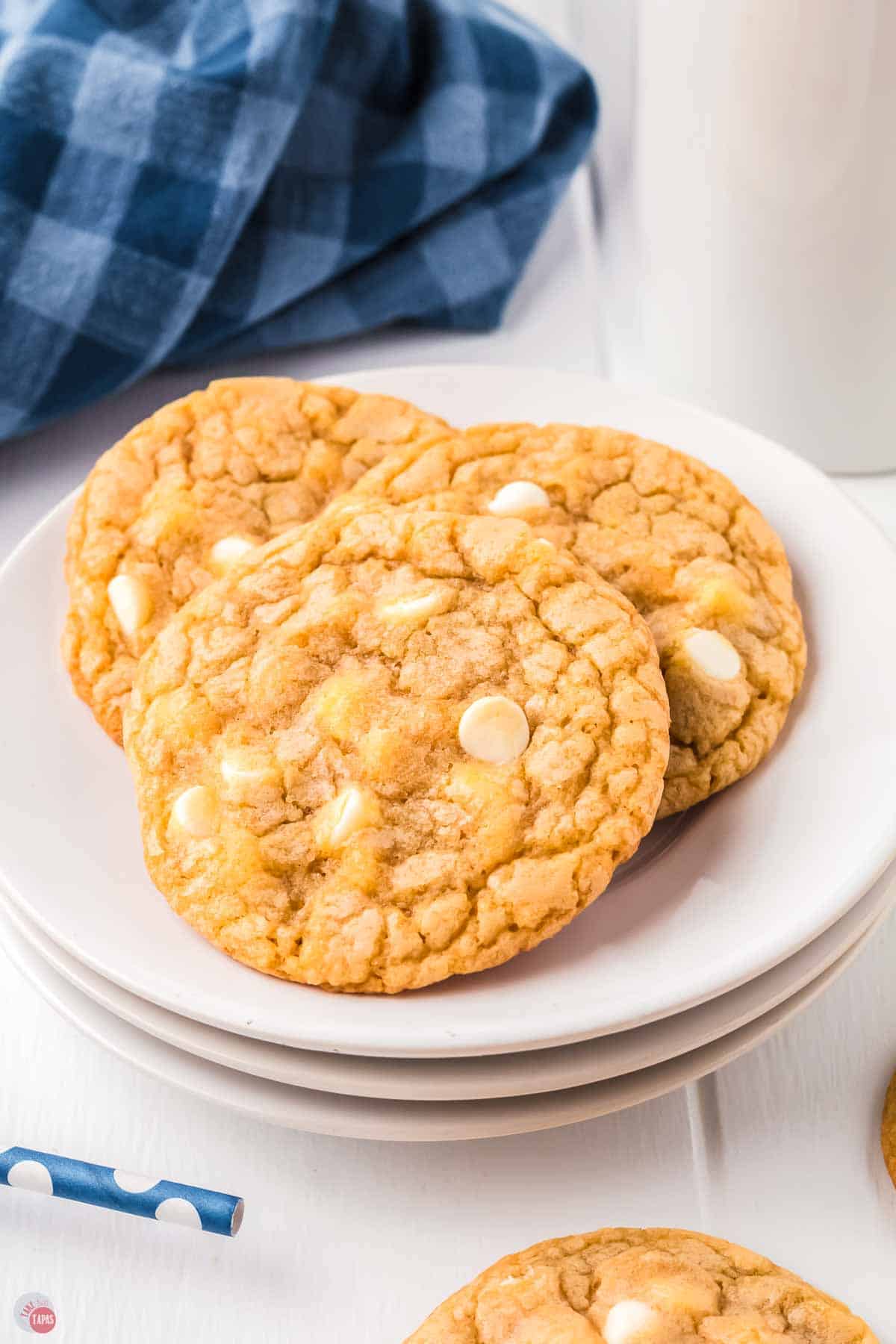 stack of white plates with three cookies on it