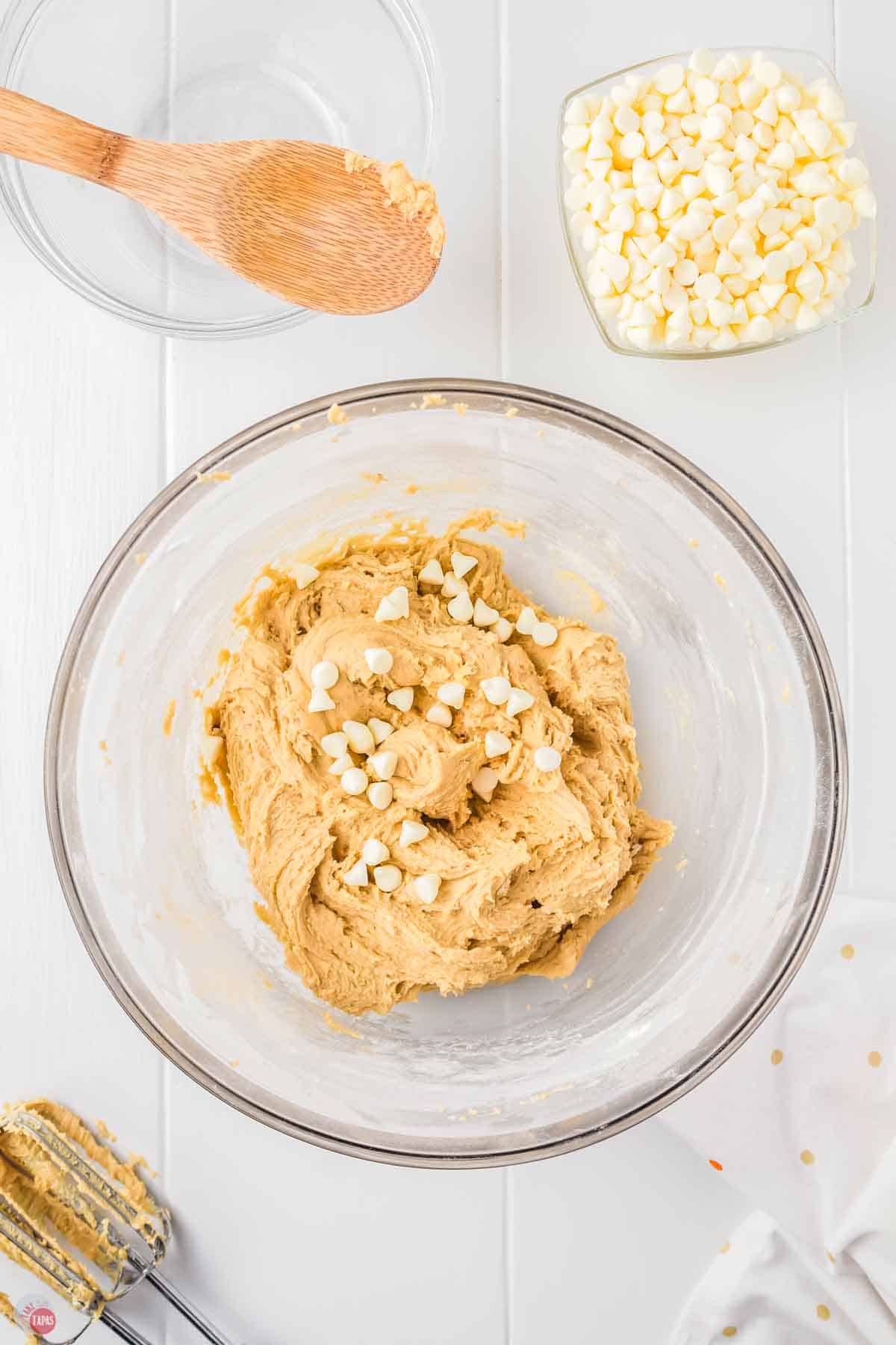 bowl of cookie dough with white chocolate chips on top