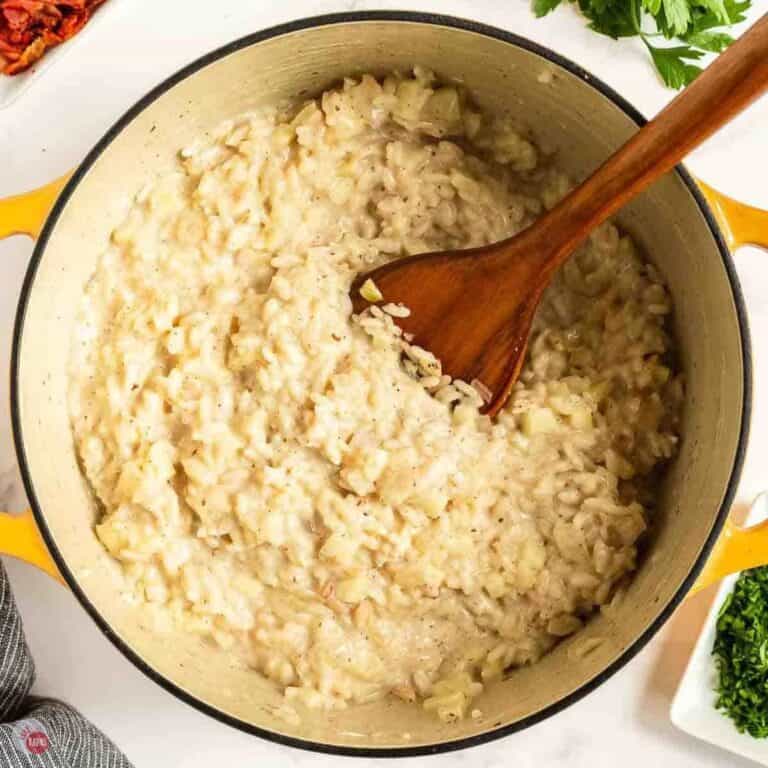 pot of apple risotto with a wood spoon