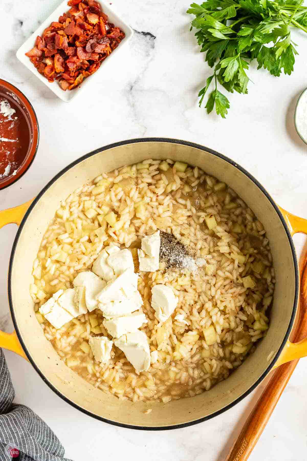 Goat cheese added to the apple risotto before stirring