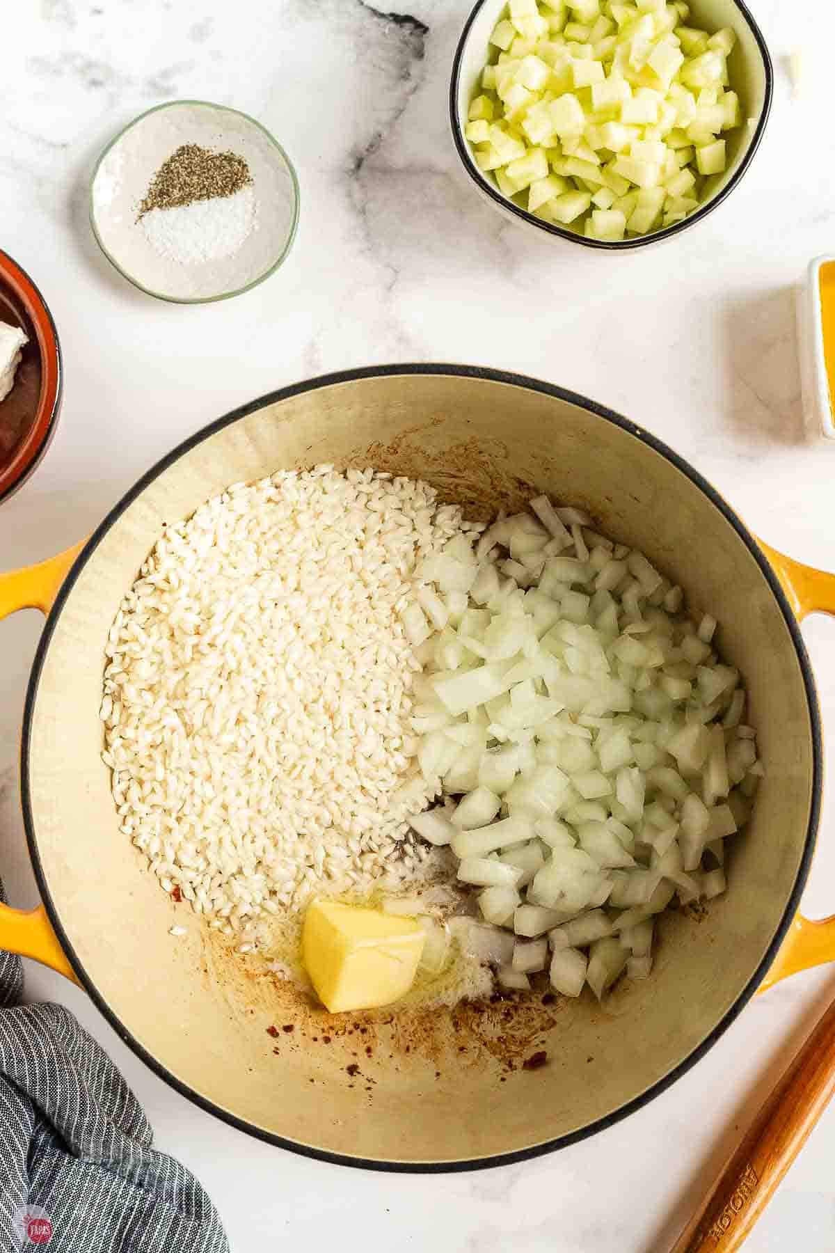Arborio rice, diced onion and butter added to the bacon fat in the pot