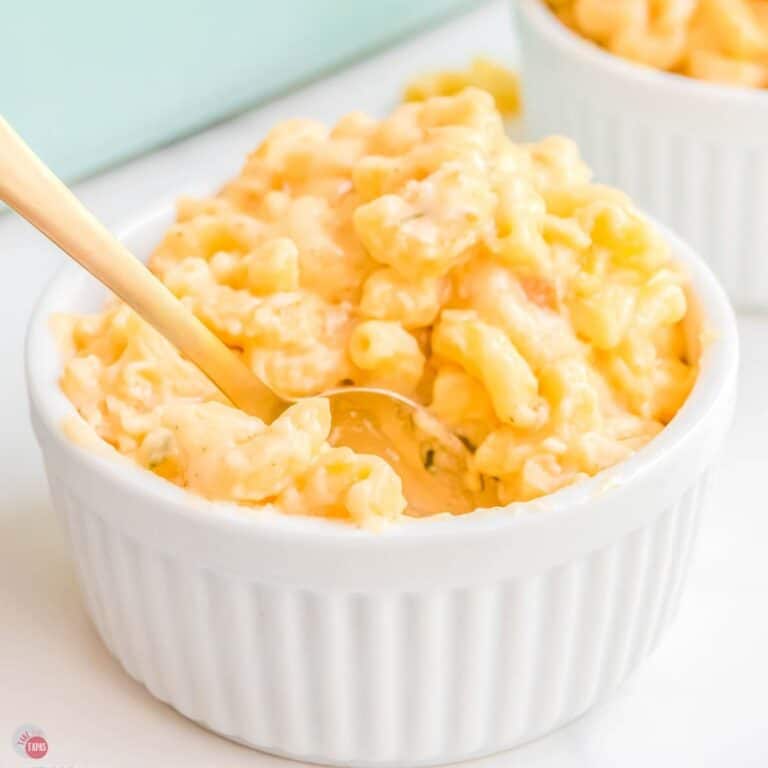 small bowl of mac and cheese with a gold spoon in it