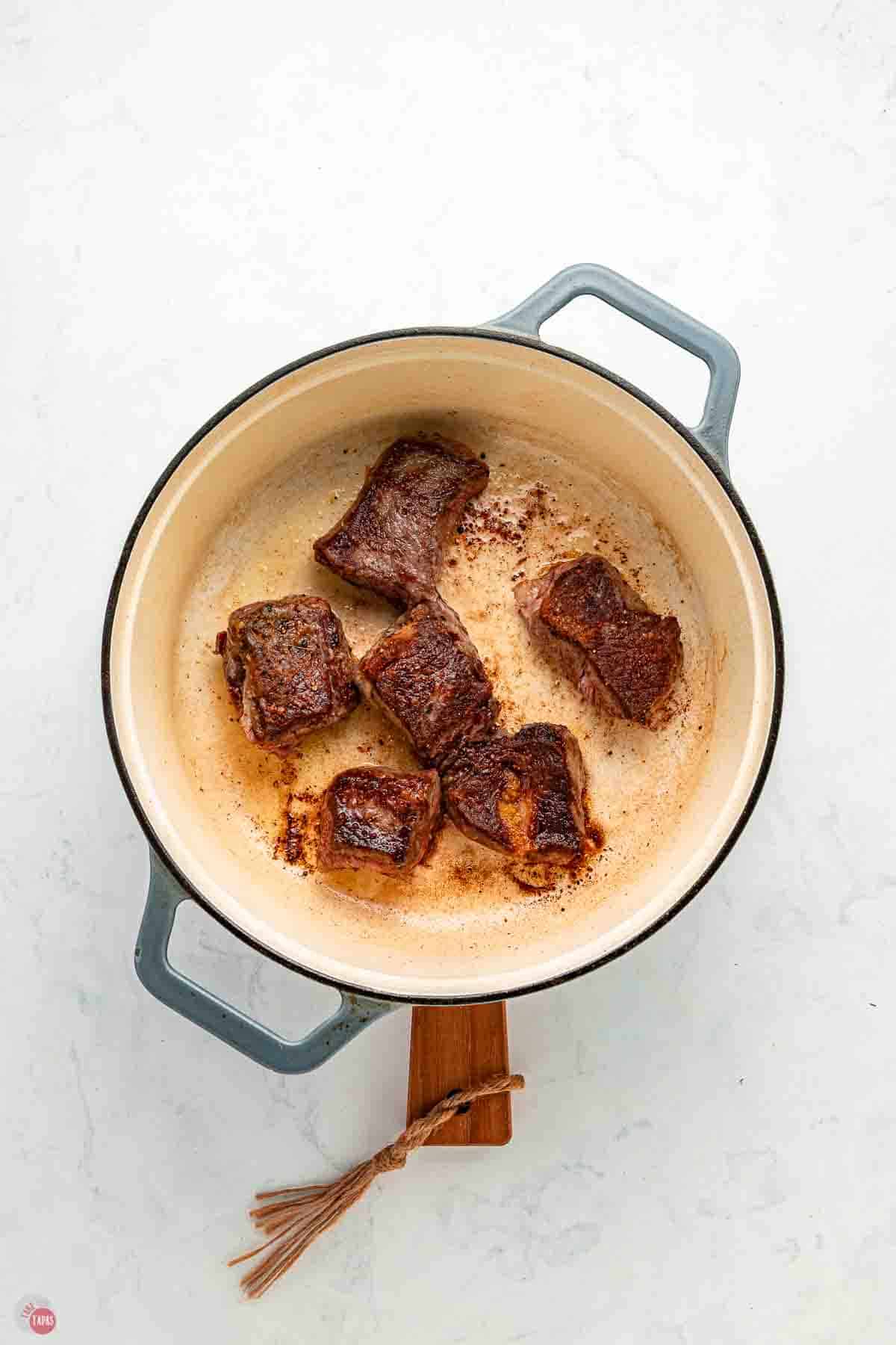 cubes of beef seared in a pot