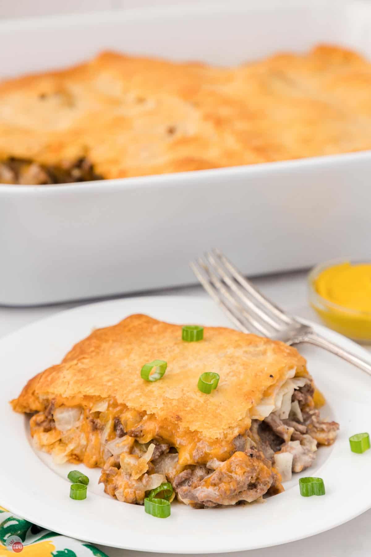 slice of beirock casserole on a plate with a fork and a dish in the background