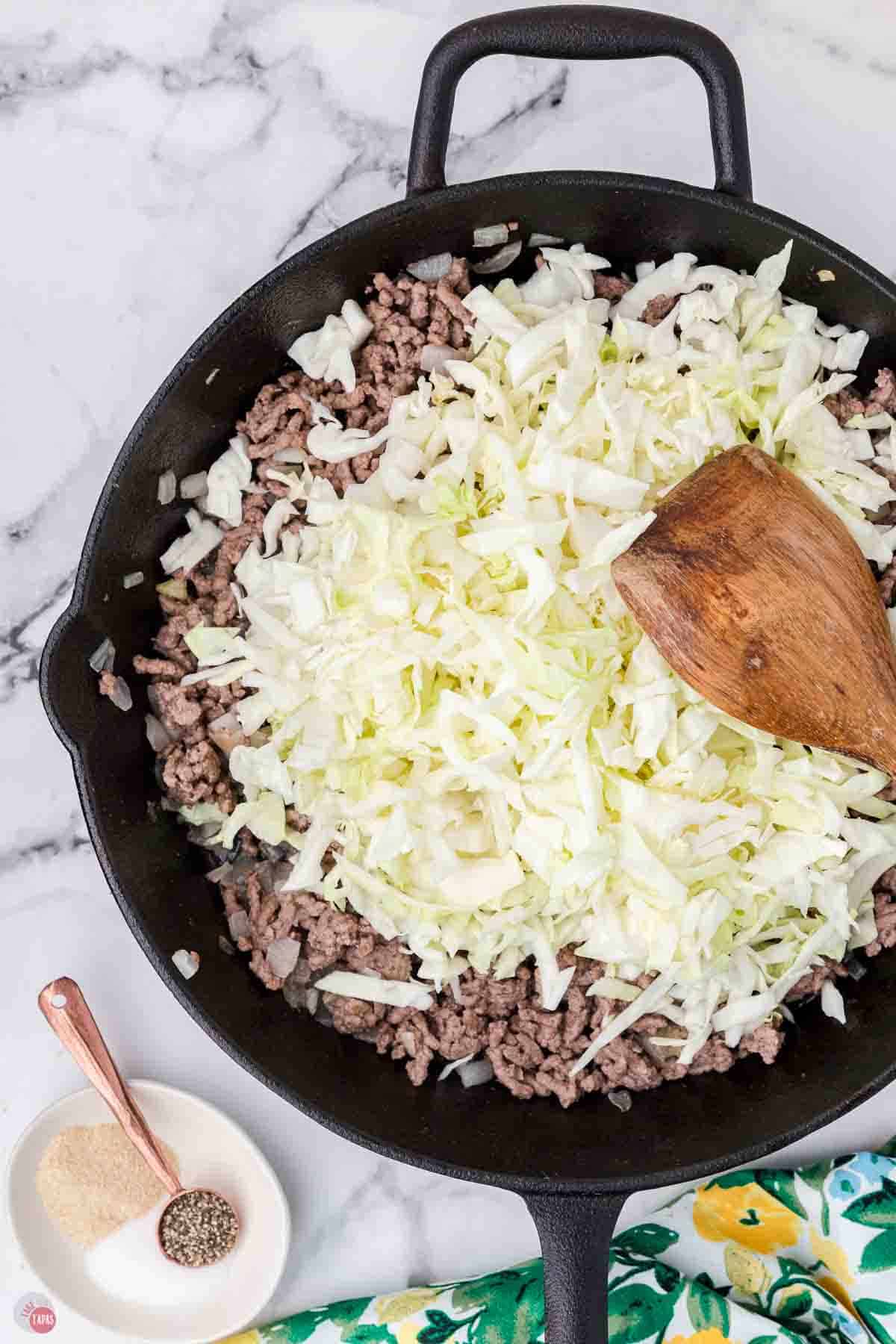 ground beef and cabbage cooking in a skillet