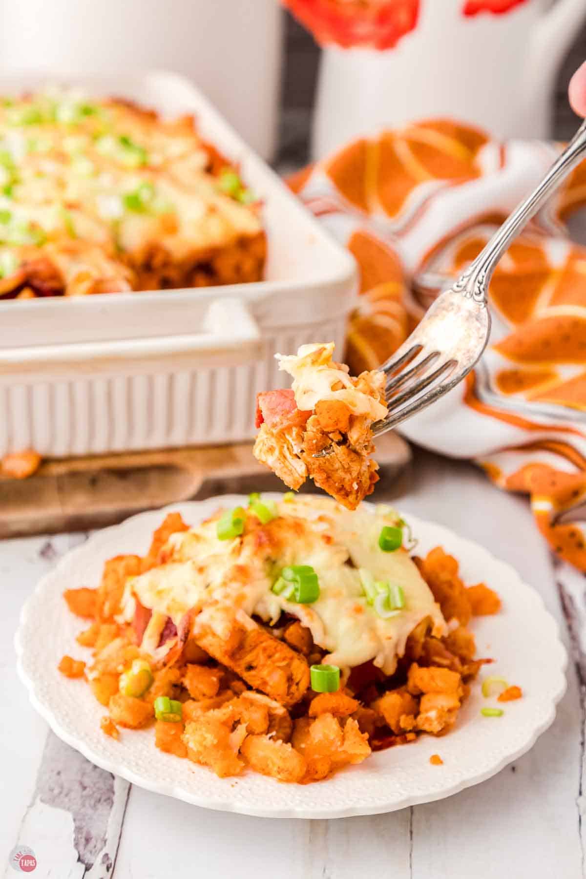 fork with bite of chicken and potatoes