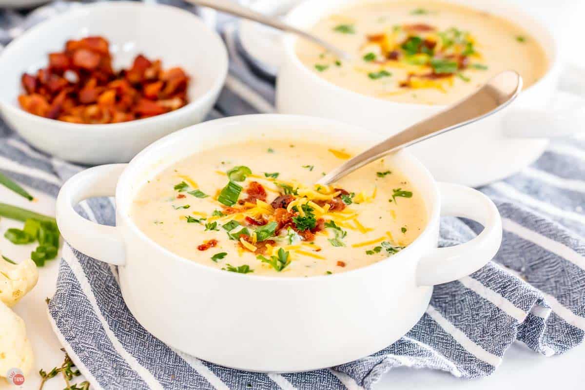 bowl of cauliflower cheese soup with a spoon