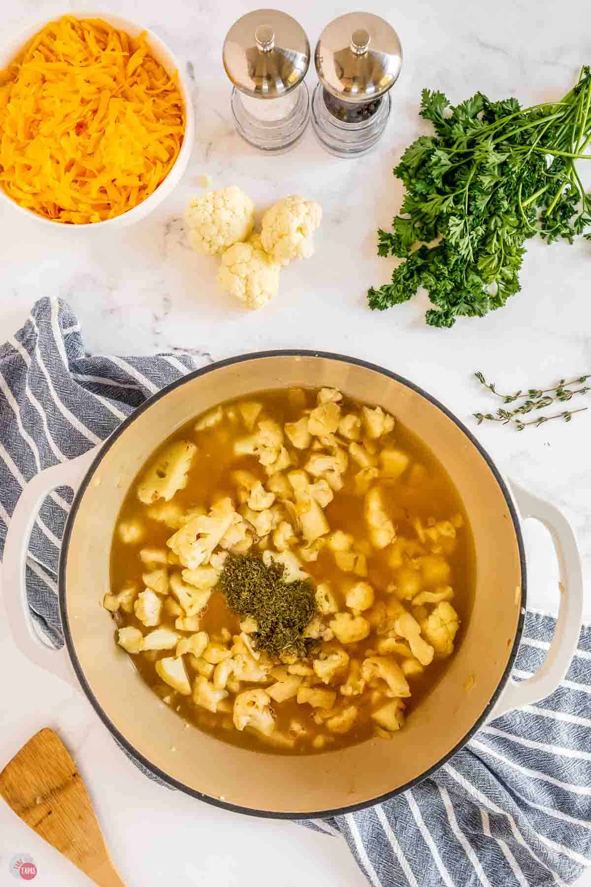 pot of broth and cauliflower florets and some dried thyme