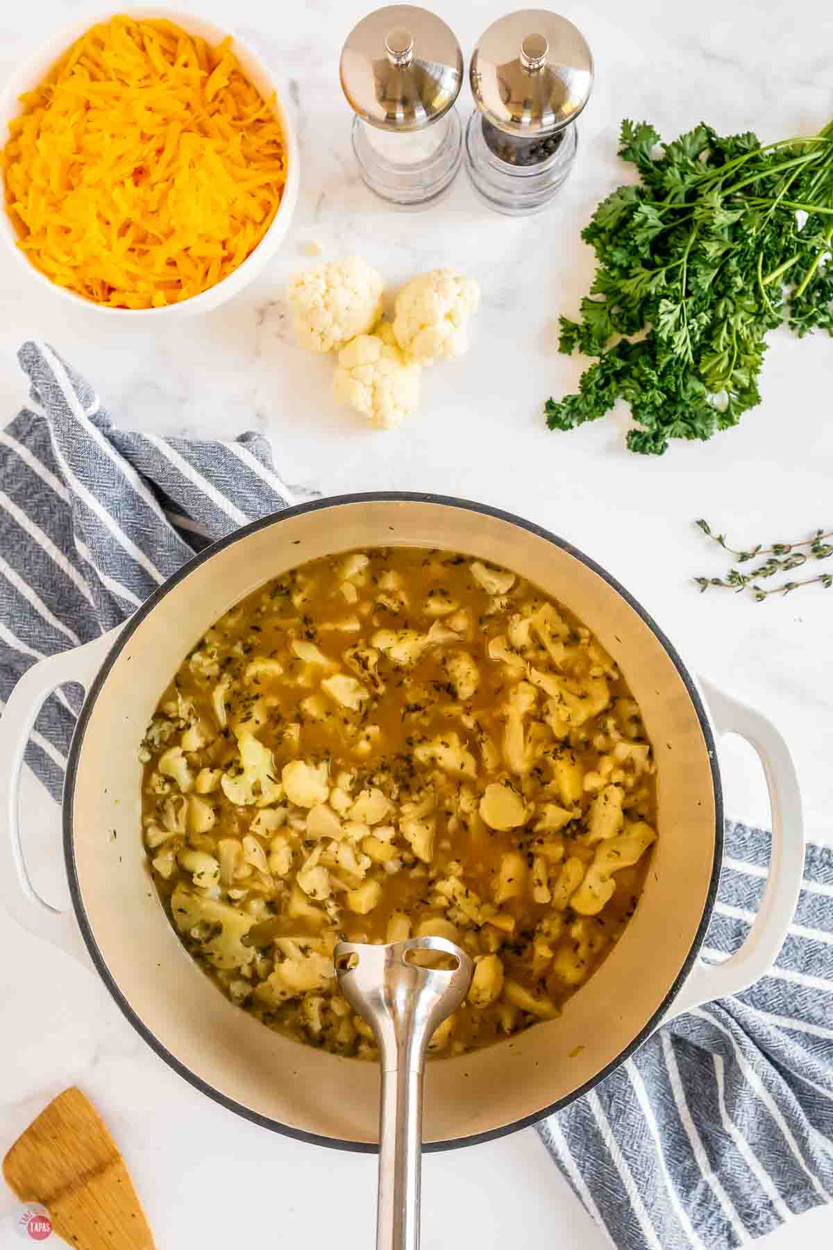 large pot with cauliflower and broth with a hand blender