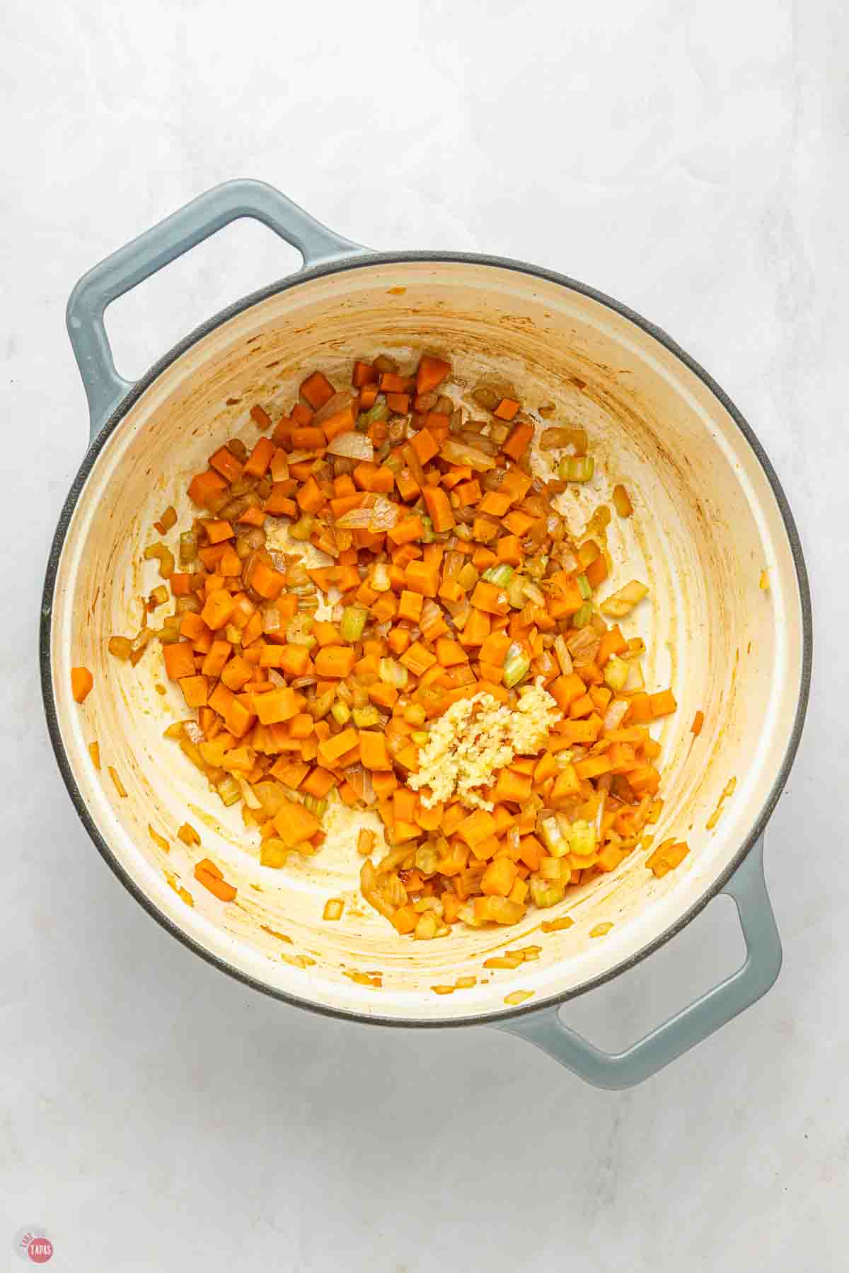 diced carrot and celery cooking in a pot