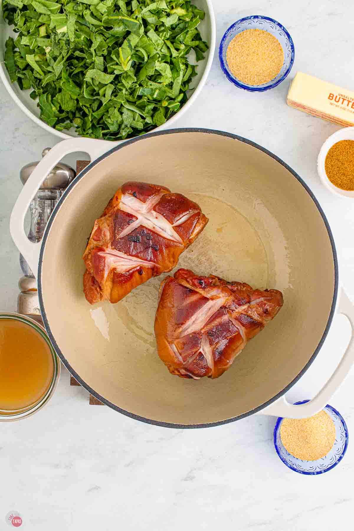 ham hocks cooking in a dutch oven