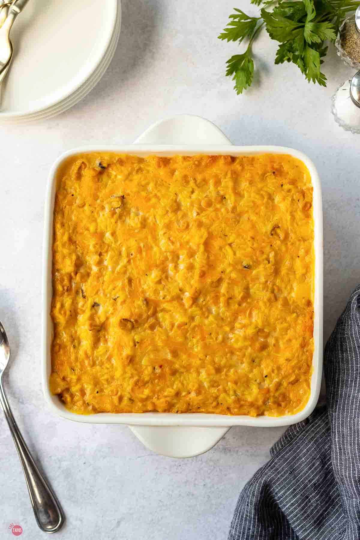 Baked corn and rice casserole with a golden, bubbly cheese top
