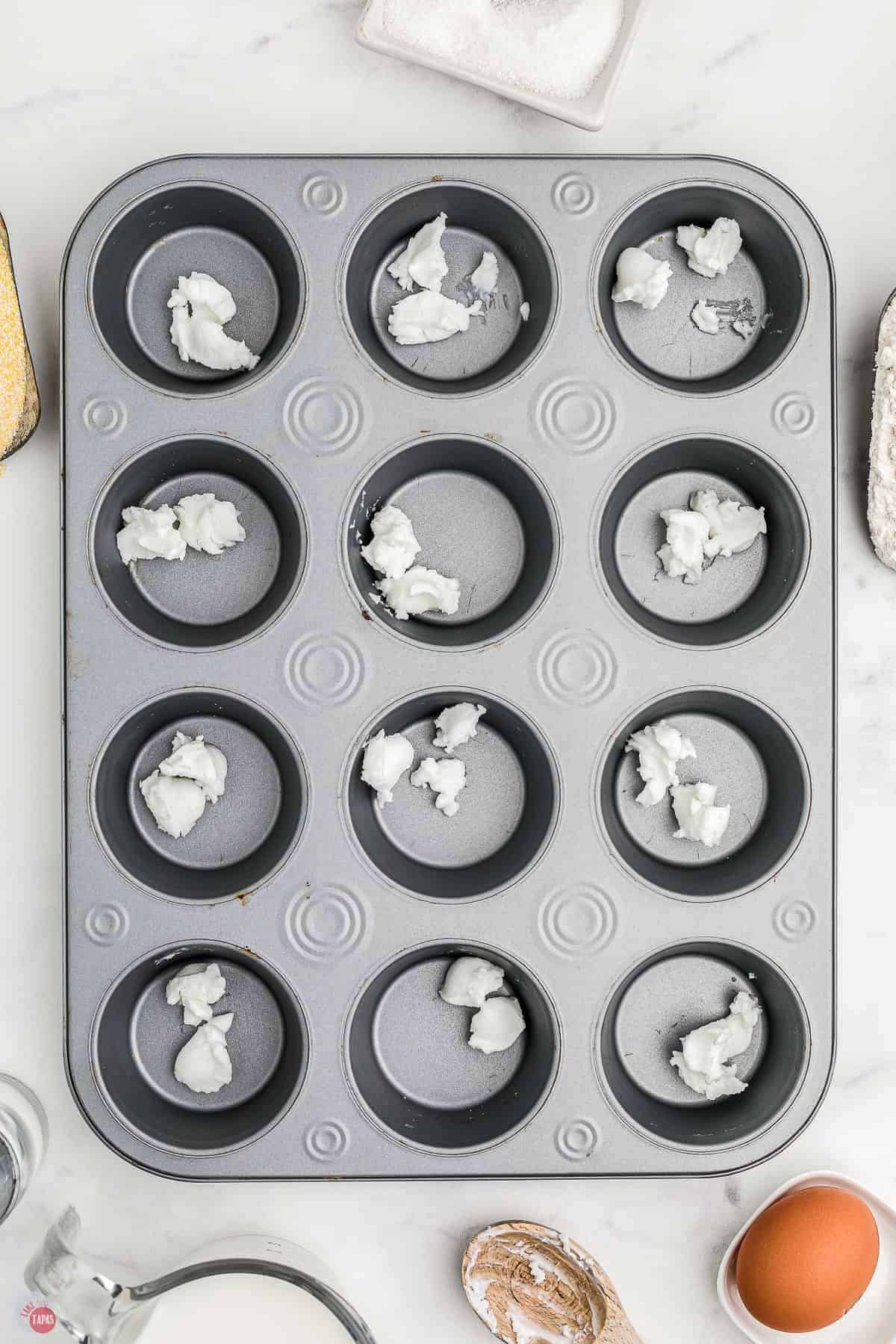 muffin pan with small amounts of shortening in each cup