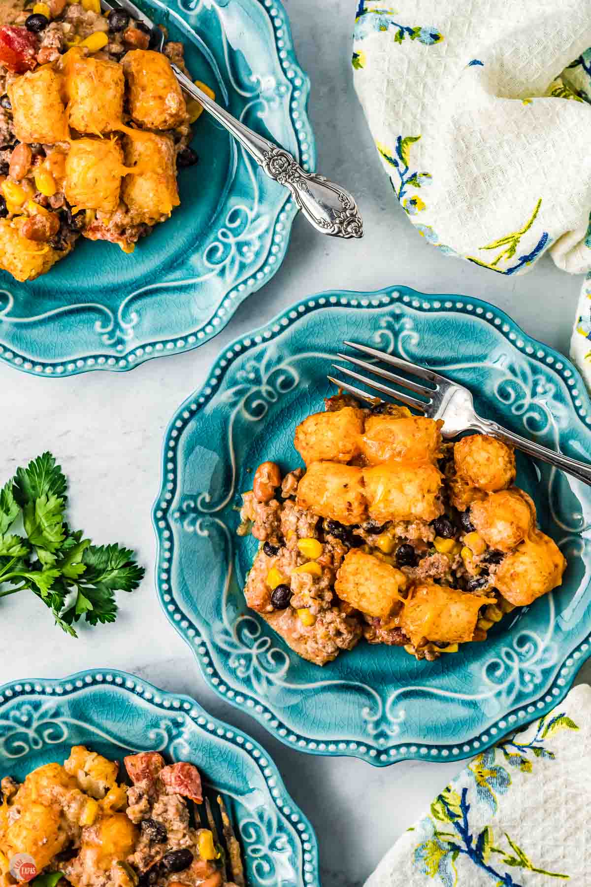 two plates of cowboy casserole with tater tots