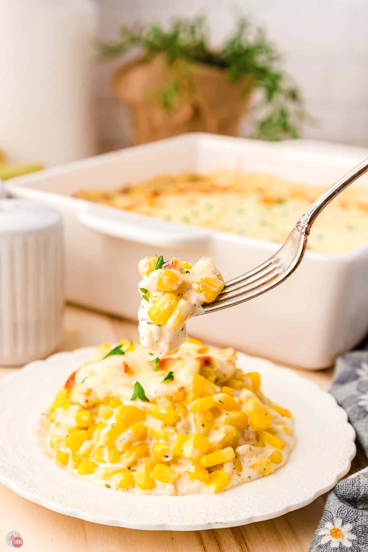 small white plate with corn recipe on it and a fork lifting a bite