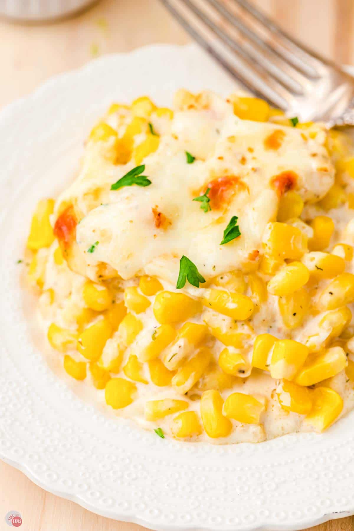 close up of corn casserole on a white plate