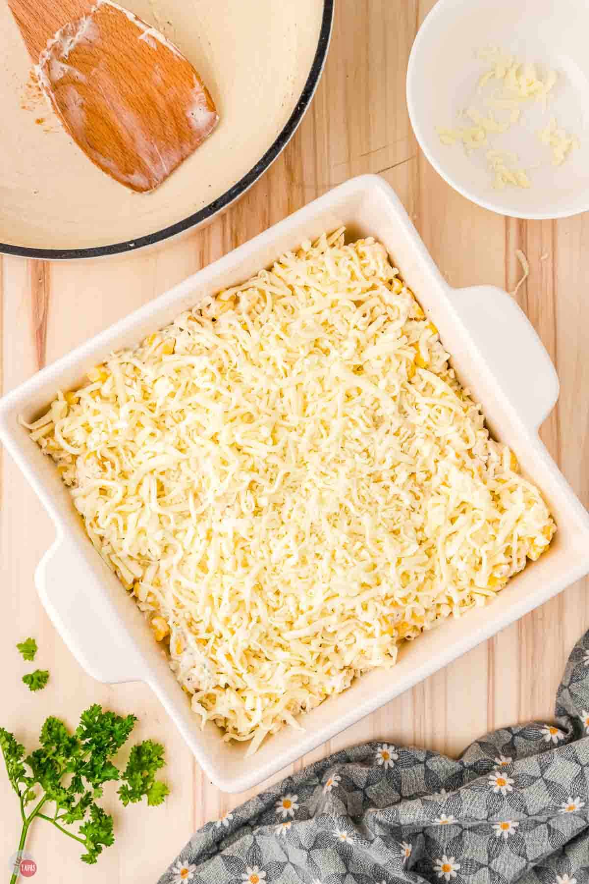 unbaked corn casserole in a square white dish