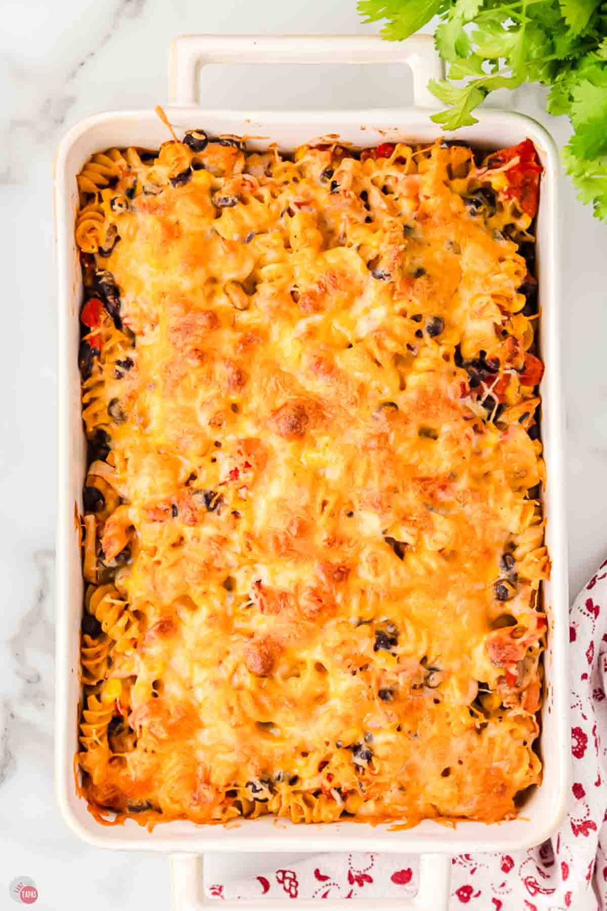 Baked fiesta chicken casserole with golden, bubbly cheese and fresh cilantro