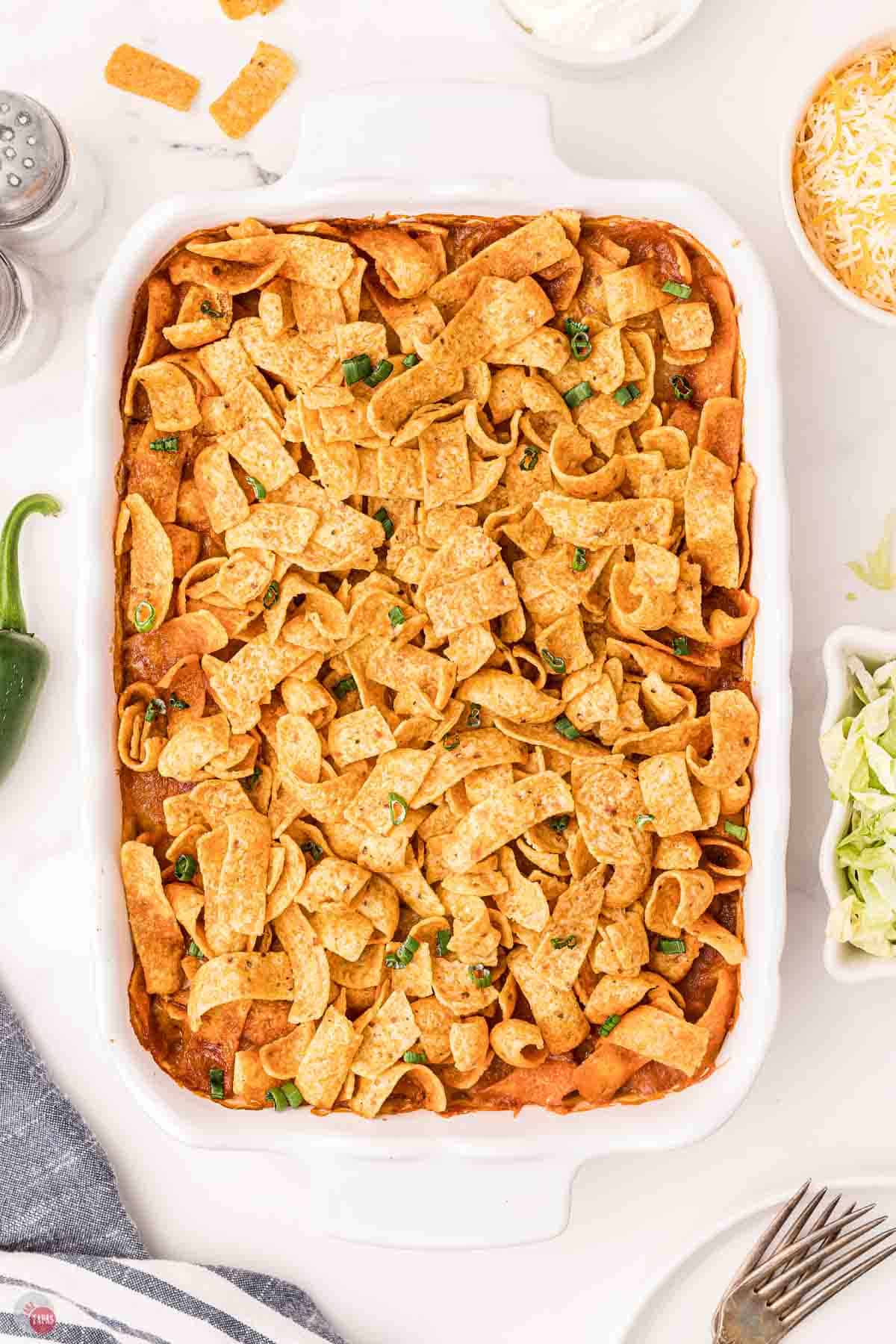 baked frito casserole in a white serving dish