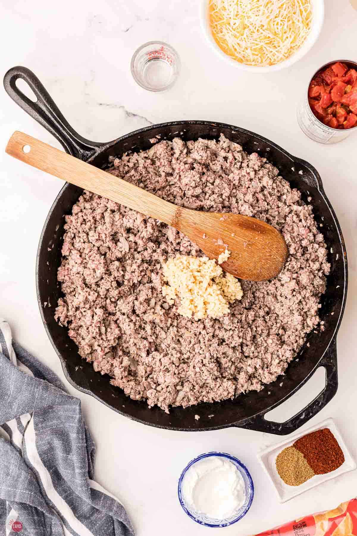 cooked ground beef in a cast iron skillet with spices