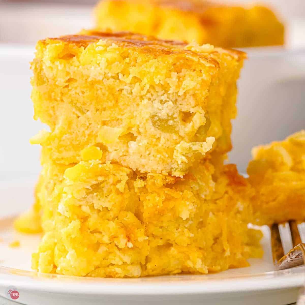 stack of two pieces of corn casserole with green chilies on a plate