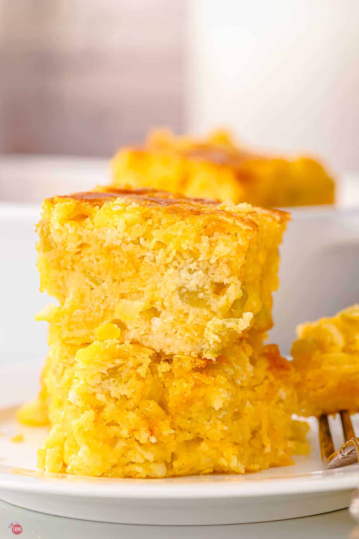 stack of two pieces of corn casserole with chopped green chilies