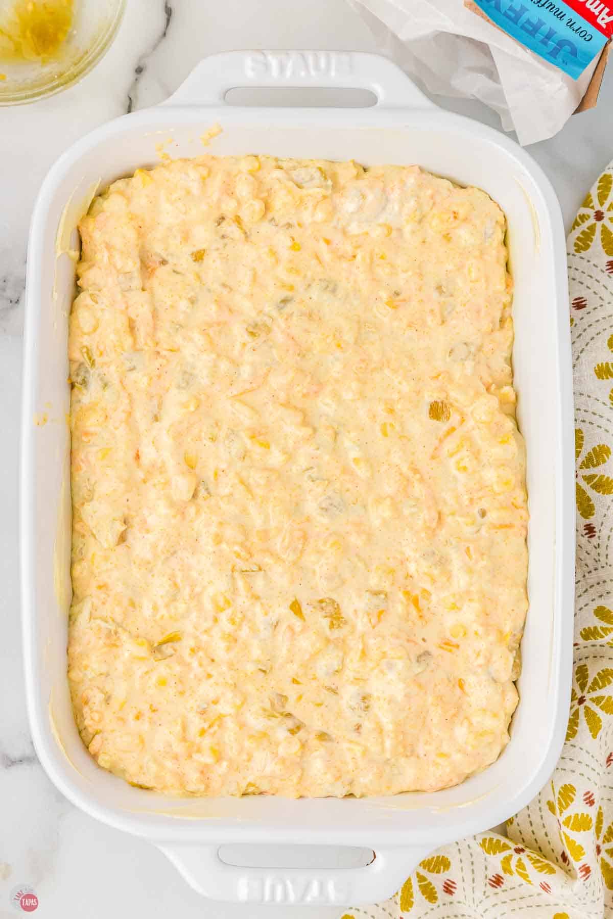 unbaked corn casserole in a white baking dish